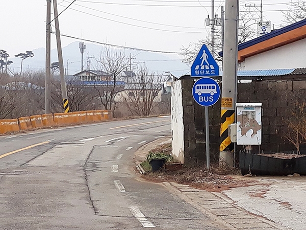 하서면 청호리. 커브길에 버스 승하차 표지판이 세워져 있다.