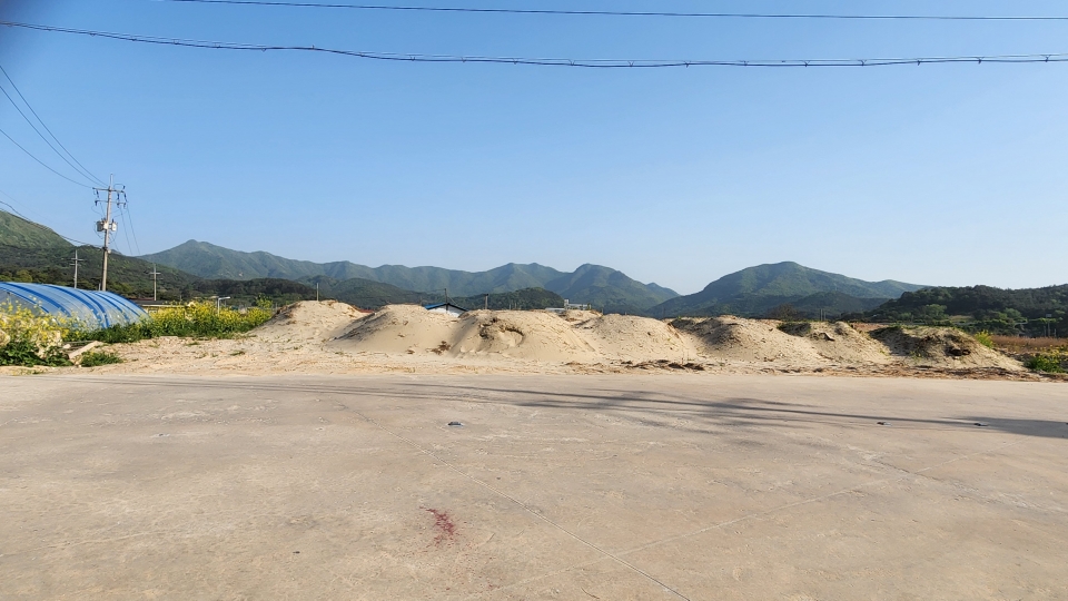 송포항 인근 사유지. 송포길에서 바라본 모습으로 사토 위에 모래가 작은 언덕을 이루고 있다.